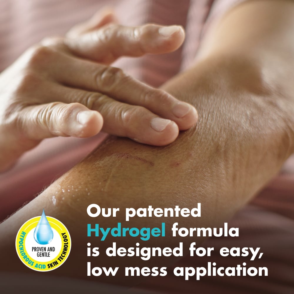 A person spreads clear gel over a scrape on a forearm. Text: “Our patented Hydrogel formula is designed for easy, low mess application”. A droplet emblem reads “HYPOCHLOROUS ACID SKIN TECHNOLOGY” and “PROVEN AND GENTLE”.